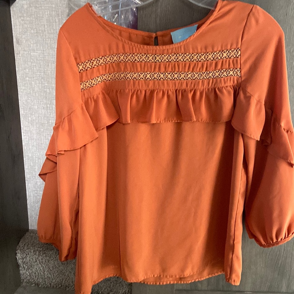 Skies Are Blue orange ruffled blouse.